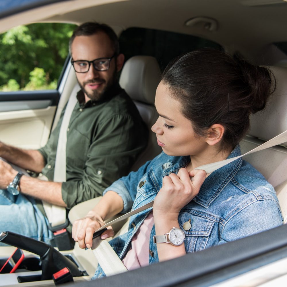 student-fastening-seat-belt-in-car-during-driving-test.jpg